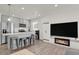 Bright and open space with kitchen island, stainless steel appliances, and cozy fireplace at 18233 E 51St Ave, Denver, CO 80249