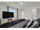 Bright main bedroom featuring a faux fireplace, TV, and ensuite bathroom access for added convenience at 18233 E 51St Ave, Denver, CO 80249