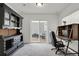 Well-lit office space with dark furniture, carpet and a sliding glass door to the exterior at 18233 E 51St Ave, Denver, CO 80249