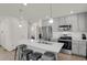 View of staircase, adjacent to modern kitchen and living area with stylish decor at 18233 E 51St Ave, Denver, CO 80249