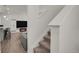 View of stairway adjacent to the kitchen and living area with fireplace at 18233 E 51St Ave, Denver, CO 80249