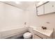 Bright bathroom features a tub and shower combo, toilet, vanity and mirrored medicine cabinet at 8195 Field Ct, Arvada, CO 80005