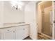 Bright bathroom with a single sink vanity and glass enclosed shower at 8195 Field Ct, Arvada, CO 80005