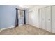 A bright bedroom featuring ample closet space and a sunny window at 8195 Field Ct, Arvada, CO 80005