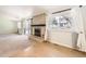 Living room featuring a brick fireplace, sliding glass door to the yard, and views to the kitchen at 8195 Field Ct, Arvada, CO 80005