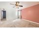 Main bedroom featuring a ceiling fan, soft lighting, and carpeted floors at 8195 Field Ct, Arvada, CO 80005