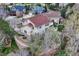 Aerial view of home showcasing lush landscaping, mature trees, and proximity to other neighborhood homes at 6556 S Versailles Ct, Aurora, CO 80016