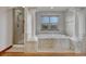 Bright bathroom with a soaking tub, glass shower, and mosaic tile at 6556 S Versailles Ct, Aurora, CO 80016