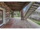 Spacious covered patio featuring stone pillars, wood beam ceiling, and stone paver flooring at 6556 S Versailles Ct, Aurora, CO 80016