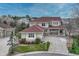 Spacious home featuring a red roof, stone accents, and a well-maintained front yard and driveway at 6556 S Versailles Ct, Aurora, CO 80016