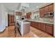 Well-lit kitchen features an island with seating, stainless steel appliances, and stylish backsplash at 6556 S Versailles Ct, Aurora, CO 80016