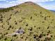 Expansive aerial view of the property, showcasing its location on a hill with breathtaking views of the surrounding landscape at 606 Sugarloaf Mountain Rd, Boulder, CO 80302