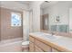 Well-lit bathroom with a combined tub and shower, neutral tiling, and a functional vanity area at 606 Sugarloaf Mountain Rd, Boulder, CO 80302