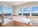 Bright bathroom with a large soaking tub and windows offering panoramic mountain views at 606 Sugarloaf Mountain Rd, Boulder, CO 80302