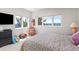 Bright bedroom with large windows showcasing mountain views, colorful accents, and a comfortable bed at 606 Sugarloaf Mountain Rd, Boulder, CO 80302