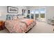Comfortable bedroom with floral bedding, a window, and French doors to a private balcony with mountain views at 606 Sugarloaf Mountain Rd, Boulder, CO 80302