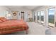Spacious bedroom with vaulted ceiling, balcony access, and scenic views of the surrounding landscape at 606 Sugarloaf Mountain Rd, Boulder, CO 80302