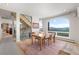 Bright dining room featuring a large picture window with mountain views and an adjacent staircase at 606 Sugarloaf Mountain Rd, Boulder, CO 80302