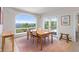 Bright dining room with an arched window and balcony access offering scenic views at 606 Sugarloaf Mountain Rd, Boulder, CO 80302