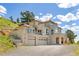 A beautiful home featuring an attached two-car garage and a private balcony at 606 Sugarloaf Mountain Rd, Boulder, CO 80302
