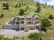 Stunning multi-story home nestled against a hillside with a multi-car garage and outdoor deck at 606 Sugarloaf Mountain Rd, Boulder, CO 80302