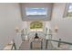 Grand foyer with mountain views, a statue, and glass-panel staircase at 606 Sugarloaf Mountain Rd, Boulder, CO 80302