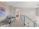 Upstairs hallway showcasing a seating area, built-in shelves, and glass railings with views down to lower level at 606 Sugarloaf Mountain Rd, Boulder, CO 80302