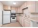 Bright kitchen with ample cabinet space, white appliances, and tile backsplash, a charming and functional space to prepare meals at 606 Sugarloaf Mountain Rd, Boulder, CO 80302