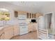 Cozy kitchen with white appliances and a view of the outside landscape at 606 Sugarloaf Mountain Rd, Boulder, CO 80302