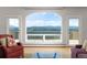 Comfortable living area featuring an arched window and access to an outdoor balcony at 606 Sugarloaf Mountain Rd, Boulder, CO 80302