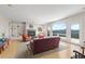 Bright living room with large arched windows offering amazing views, built-in shelves, and a cozy fireplace at 606 Sugarloaf Mountain Rd, Boulder, CO 80302