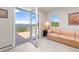 Cozy room featuring a door to the outdoor deck, a large picture window and a comfortable couch at 606 Sugarloaf Mountain Rd, Boulder, CO 80302