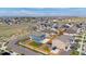 Neighborhood aerial shot showcasing tidy lawns, a play set, and a friendly atmosphere with easy access to community amenities at 902 William Way, Brighton, CO 80603