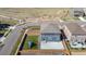 Birds-eye view of fenced yard with a playground set and patio, nestled in a meticulously planned, Gathering-oriented community at 902 William Way, Brighton, CO 80603