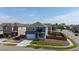 An aerial shot of a gray and blue two-story home with fenced backyard in a residential neighborhood at 902 William Way, Brighton, CO 80603