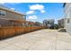 Spacious backyard featuring a concrete patio, wood fence, pergola, and a play area, perfect for outdoor activities and relaxation at 902 William Way, Brighton, CO 80603