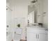 Bright bathroom featuring a single sink vanity, toilet, and shower with tub at 902 William Way, Brighton, CO 80603