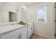 Well-lit bathroom featuring a double sink vanity with garden views from the window at 902 William Way, Brighton, CO 80603