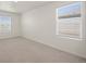 Spacious bedroom with two large windows and neutral colored carpeting at 902 William Way, Brighton, CO 80603