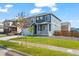 Charming two-story home with a well-maintained lawn and inviting front porch at 902 William Way, Brighton, CO 80603