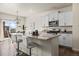 Bright kitchen with granite countertops, stainless steel appliances, and bar seating at 902 William Way, Brighton, CO 80603