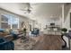 Open-concept living space with hardwood floors, lots of light, and a modern kitchen at 902 William Way, Brighton, CO 80603