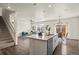 Bright, open-concept kitchen and living area with sleek appliances and stylish design at 902 William Way, Brighton, CO 80603