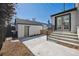 Cozy backyard with concrete patio, steps leading to the back entrance, and a detached garage at 4022 E 17Th Avenue Pkwy, Denver, CO 80220