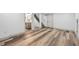 Basement with hardwood floors leading to the bathroom and stairs to the main floor at 4022 E 17Th Avenue Pkwy, Denver, CO 80220