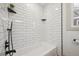 Contemporary bath boasts a subway tile surround and sleek black fixtures at 4022 E 17Th Avenue Pkwy, Denver, CO 80220