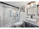 Modern bathroom featuring a glass-enclosed shower, stylish vanity, and pebble floor at 4022 E 17Th Avenue Pkwy, Denver, CO 80220