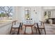 Bright dining room with a glass table and wood chairs by the window at 4022 E 17Th Avenue Pkwy, Denver, CO 80220