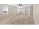 Spacious room with neutral carpet and paint and a ceiling fan, with a large bay window with custom window treatments at 15715 Carob Cir, Parker, CO 80134