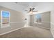 This bedroom features neutral walls, carpeted floors, a ceiling fan, and plenty of natural light at 15715 Carob Cir, Parker, CO 80134